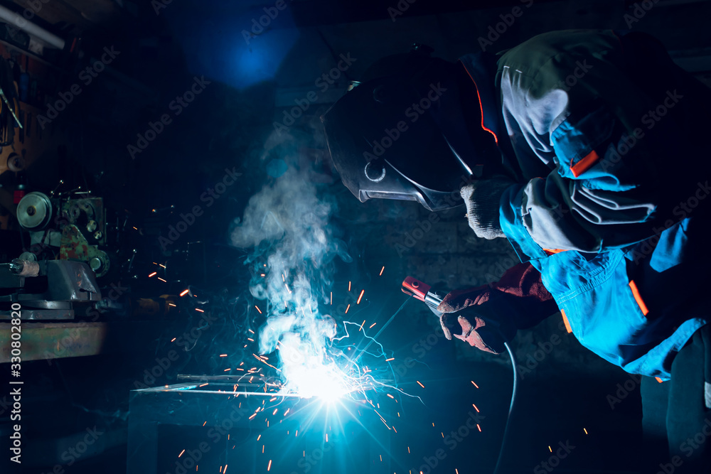 Welders working at the factory made metal Welders working at the factory made metal