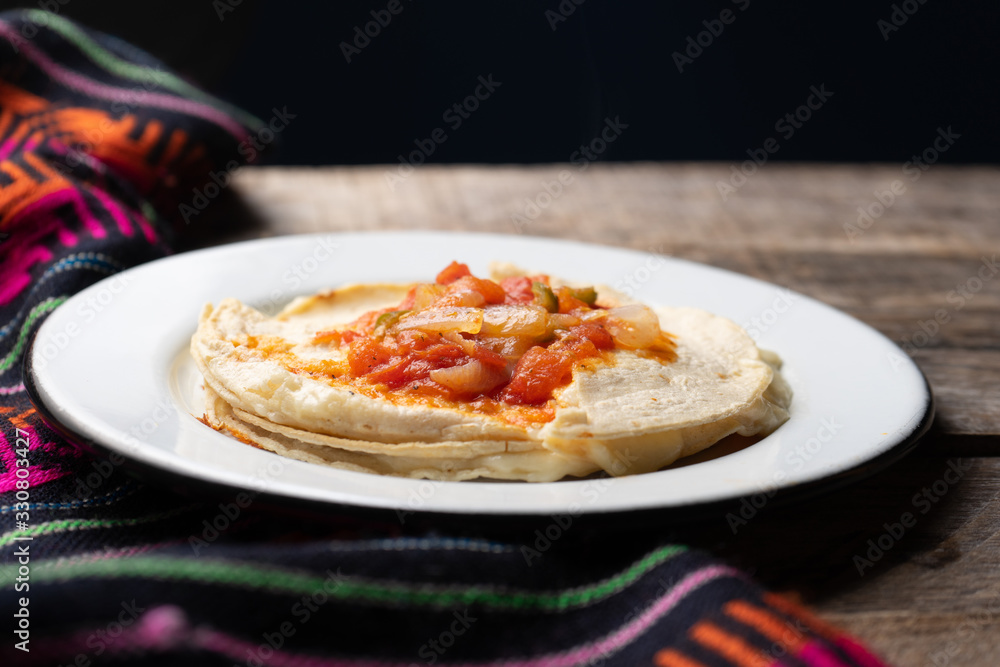Mexican quesadilla with corn tortilla and piquant sauce also called Mexican quesadilla with corn tortilla and piquant sauce also called