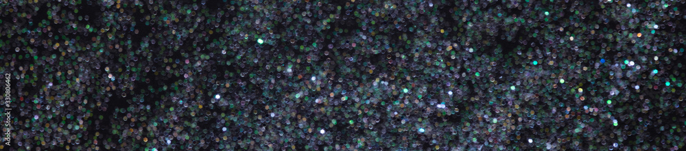 Abstract elegant glitter sparkle bokeh defocused on black background banner