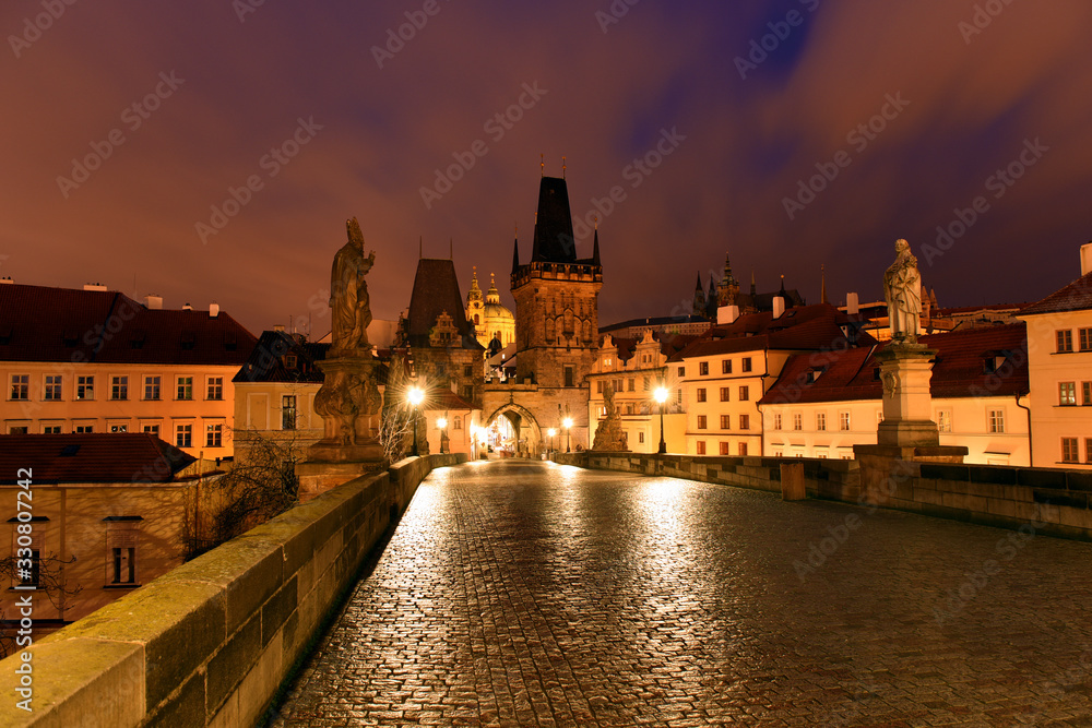 Prague, Czech Republic - Charles bridge with its statuette, Lesser Town Bridge Tower and the tower of the Judith Bridge in The Mala Strana while sunset