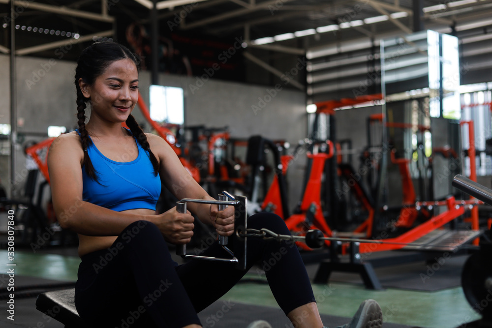 Fototapeta premium Asian woman in fitness gym