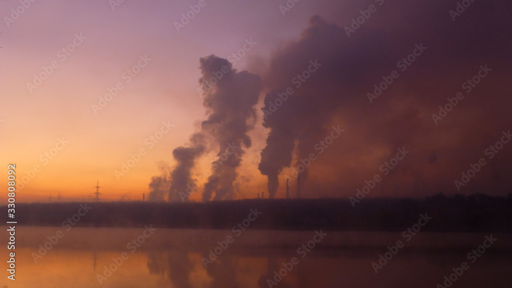 Poisoned air. Industrial landscape at dawn. Metallurgical factory background.