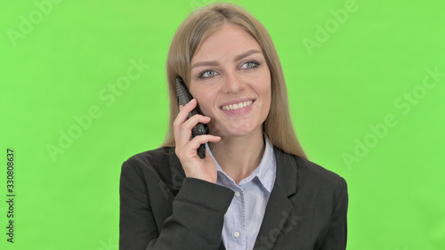 Young Businesswoman Talking on Smartphone against Chroma Key