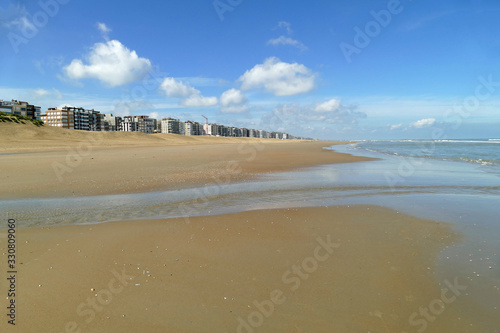 Panorama view of the broad beach in Koksijde at low tide on a beautiful day; Belgium, Europe