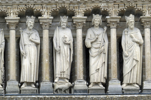 Close-up of sculptures / statues of four saints at the facade of Notre-Dame de Paris; Paris, France, Europe