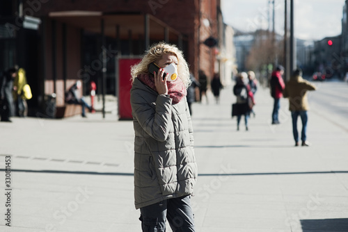 COVID-19 Pandemic Coronavirus Young girl in city street wearing face mask protective for spreading of Coronavirus Disease 2019. Close up of young woman with surgical mask on face against