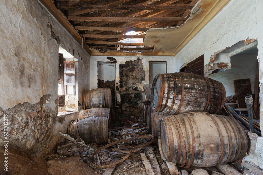Old abandoned wine cellar with barrels in Casabermeja, Malaga. Spain