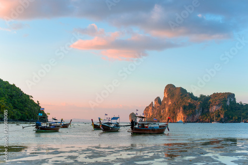 Charming sunset over a tropical island. Low tide, fishing boats.