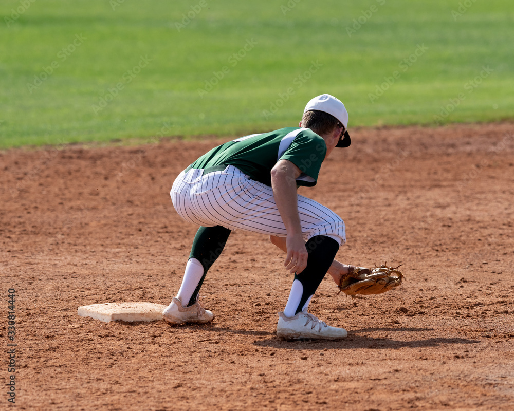 Young Boy catching and throwing the ball during a competitive baseball game Young Boy catching and throwing the ball during a competitive baseball game