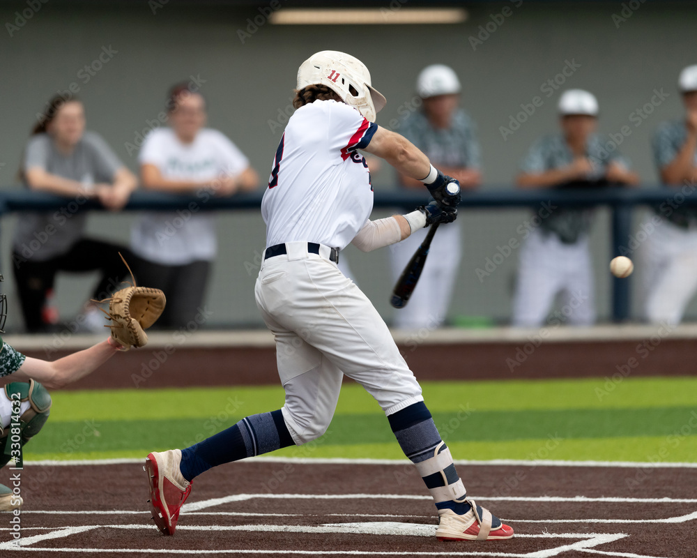 Fototapeta premium Young boy swinging the bat for a hit in a baseball game