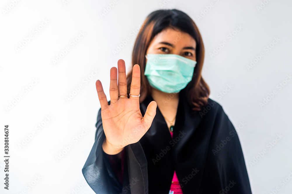 Young Asian woman using face mask with hand showing protection concept of Corona virus or Covid-19 virus outbreak in Asia Young Asian woman using face mask with hand showing protection concept of Corona virus or Covid-19 virus outbreak in Asia