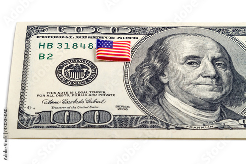 $100 dollar bill and tiny volumetric flag photo