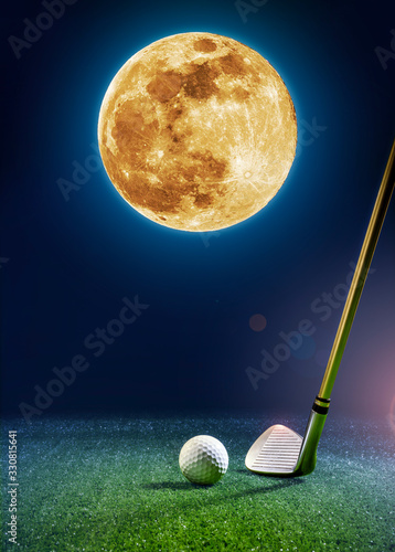 Golf club and golf ball on the turf with a beautiful moon in the background