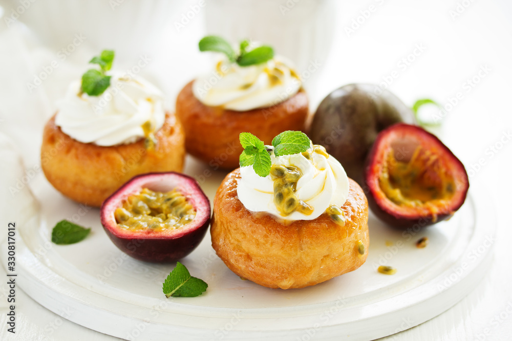 Rum woman (brioche) with cream and passion fruit. Dessert. Selective focus Rum woman (brioche) with cream and passion fruit. Dessert. Selective focus