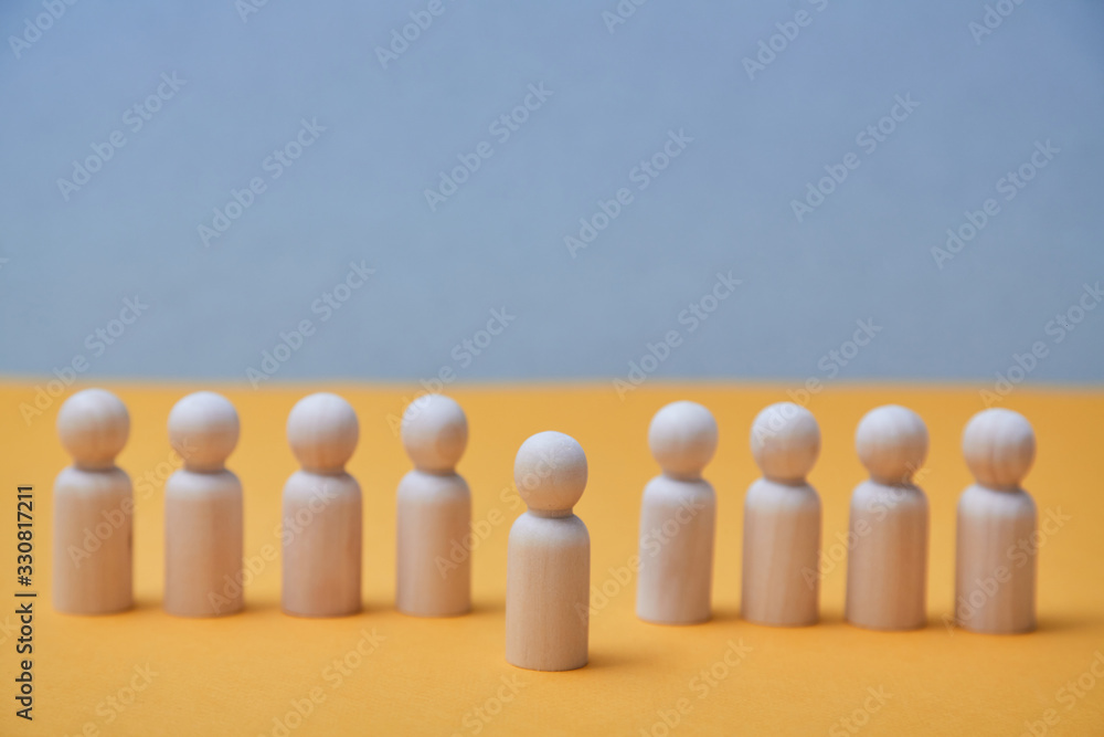 Thinking outside the box. Individual approach. Leadership and individuality. Wooden person figure stands out from crowd Thinking outside the box. Individual approach. Leadership and individuality. Wooden person figure stands out from crowd