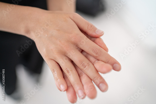 Fototapeta Naklejka Na Ścianę i Meble -  Hand sanitizer Corona virus COVID-19 prevention alcohol gel rub for hand hygiene prevention. Woman rubbing soap in palms to clean hands.