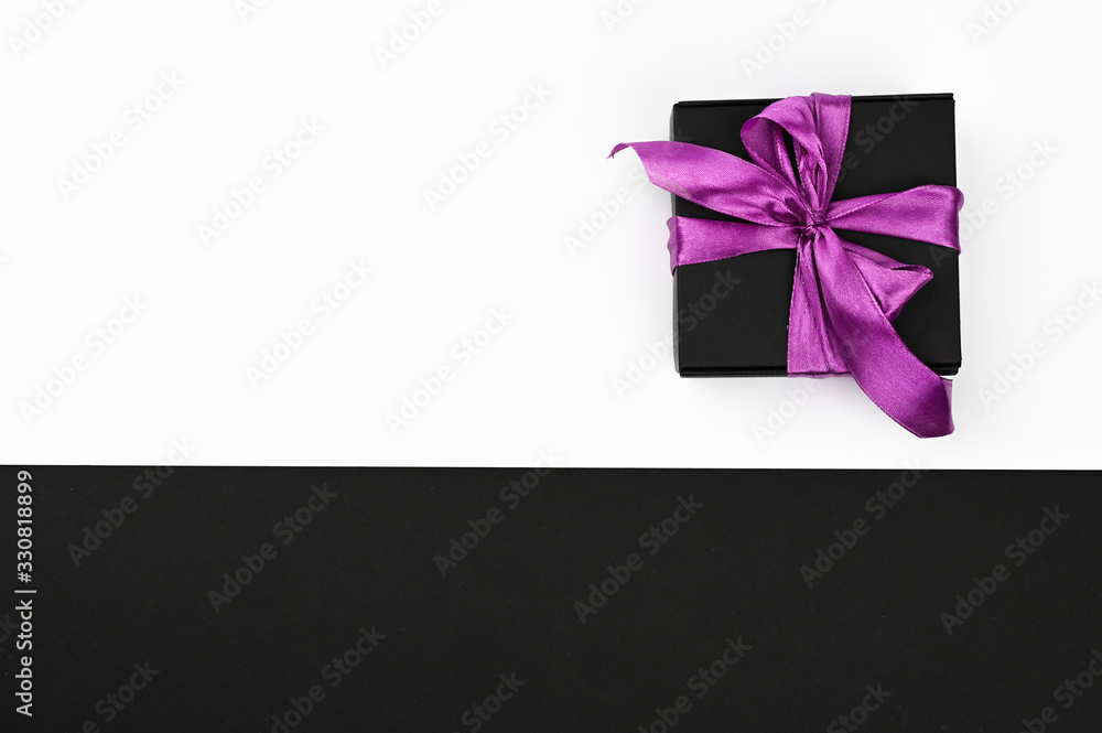 Gift wrapping by bow on a black and white background Gift wrapping by bow on a black and white background