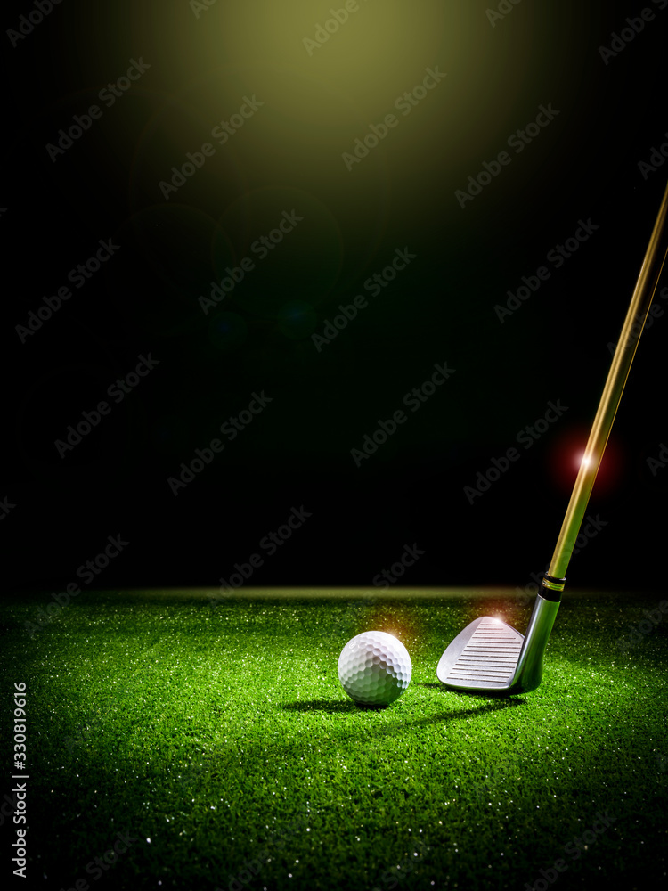 Beam of light illuminating a golf club and a golf ball on the lawn