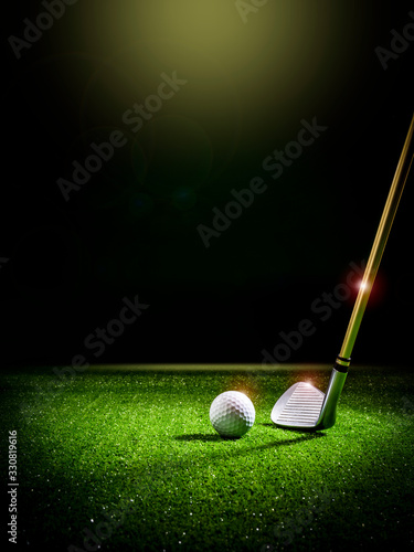 Beam of light illuminating a golf club and a golf ball on the lawn