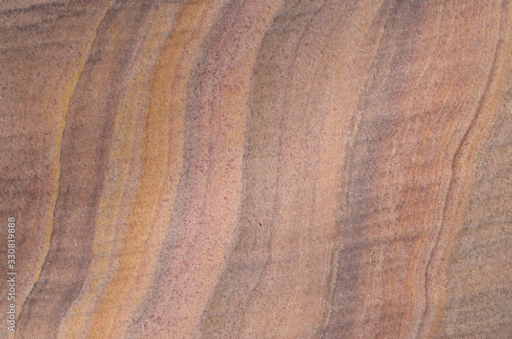 Fototapeta premium Colorful sandstone with layers on wall closeup