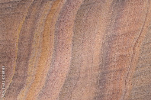 Colorful sandstone with layers on wall closeup