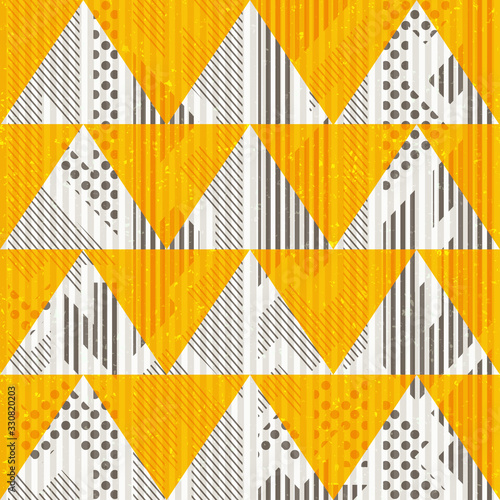 Yellow color seamless geometric pattern with triangles