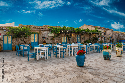 Typical italian outdoor cafe in beautiful and colorful sicilian village Marzamemi in province of Syracuse in Sicily, Italy photo