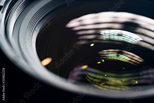 The camera lens photographed close-up on a dark background.