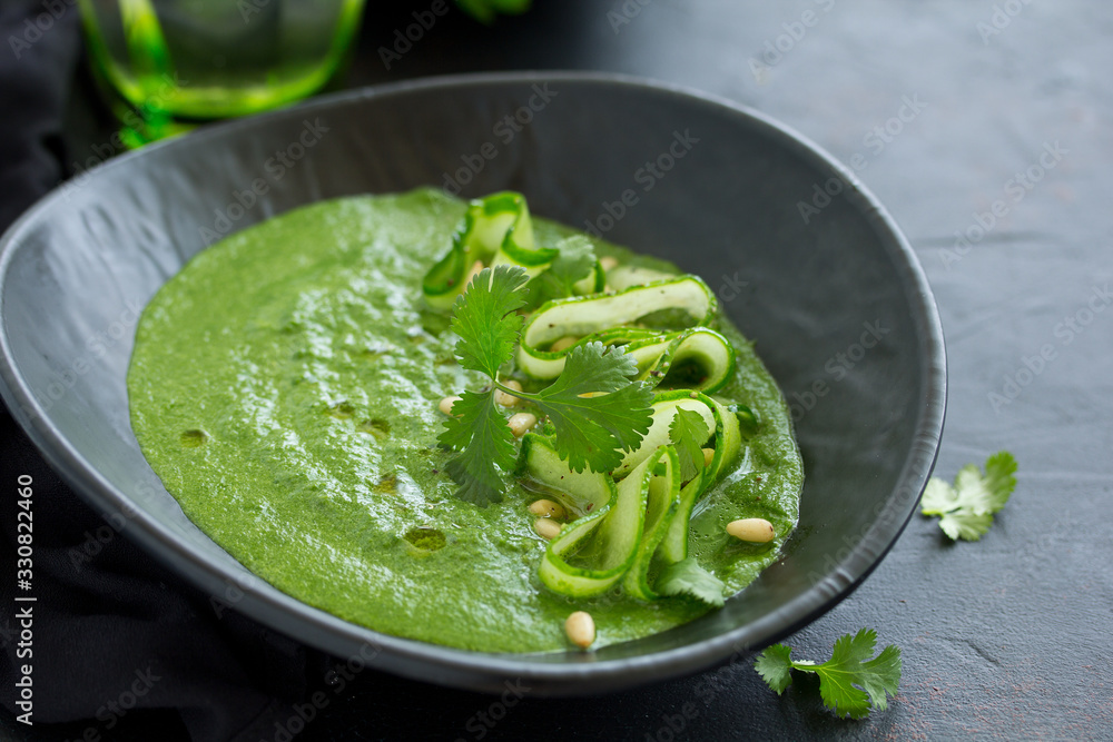 Green cold spinach and cucumber soup. Selective focus. Green cold spinach and cucumber soup. Selective focus.