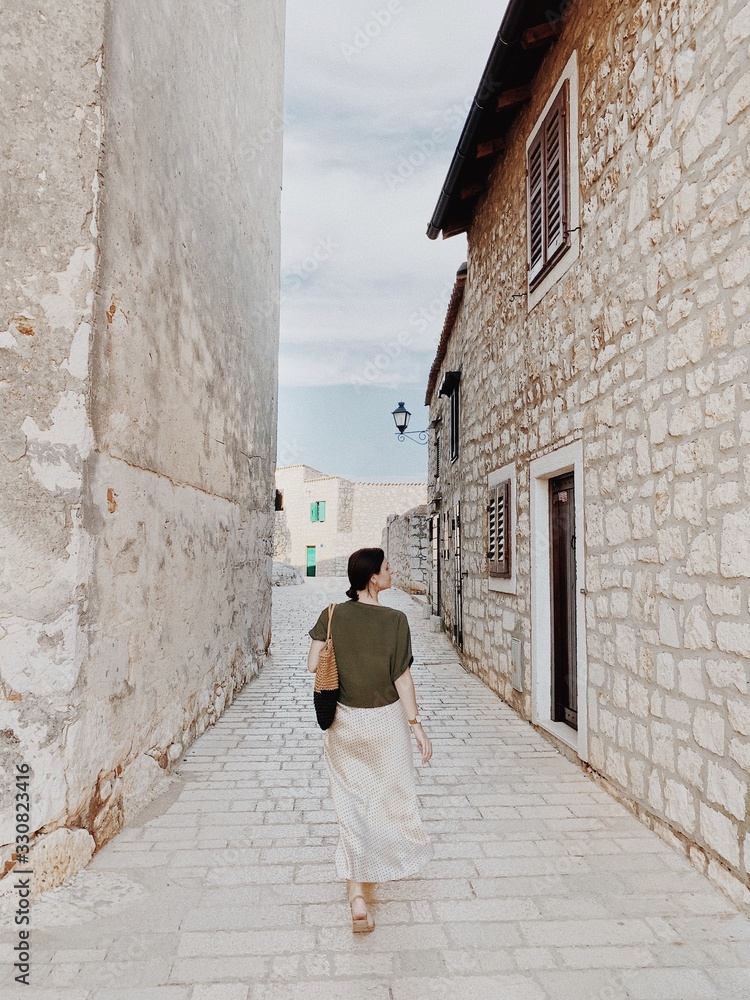 Travel summer Europe concept. Young girl walking on the narrow street of Rovinj, Istria region, Croatia, Europe 2019. Travel background.