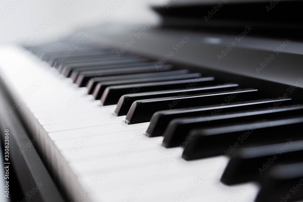 Close-up of electric piano keys, shallow depth of field. Music industry. Copy space