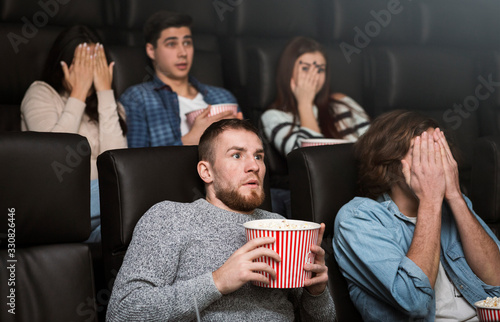Frightened spectators on scary movie premier in cinema