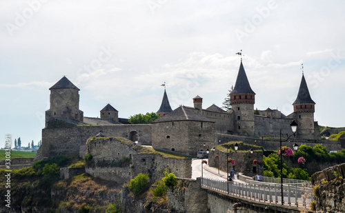 Summer landscape, view on the medieval Kamianets-Podilskyi castle located in Khmelnytsky region of Ukraine. Very popular among tourists. photo