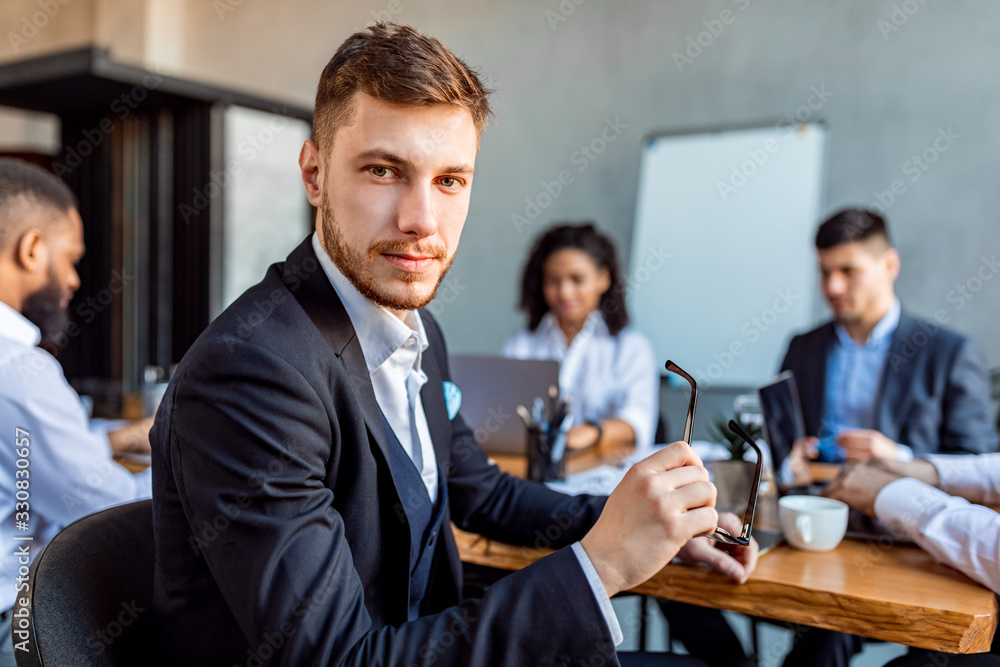 Entrepreneur On Business Meeting Looking At Camera Sitting In Office Entrepreneur On Business Meeting Looking At Camera Sitting In Office