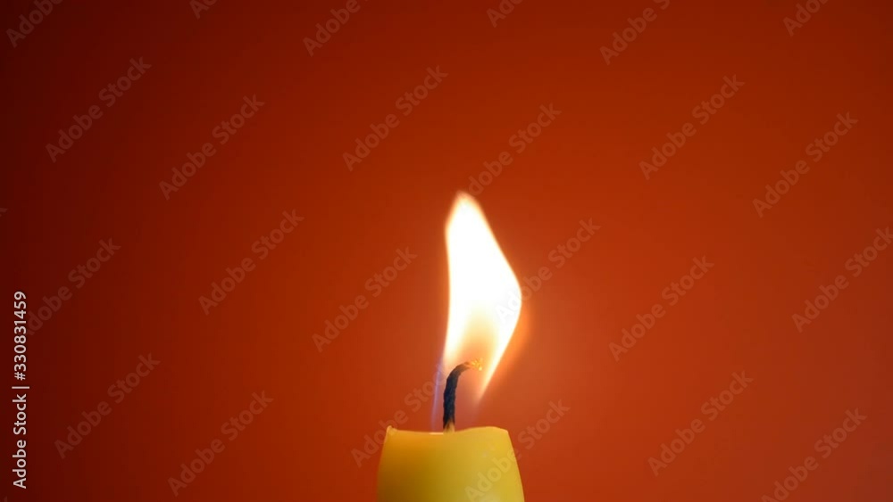 Candle flame close-up on a red background Candle flame close-up on a red background