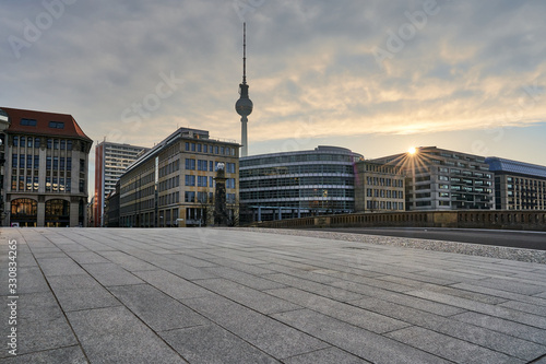 beautiful cityscape from the skyline of Berlin at sunrize, TV-Tower behind colourful modern and old buildings at the friedrichs bridge, blue sky with some clouds at dawn