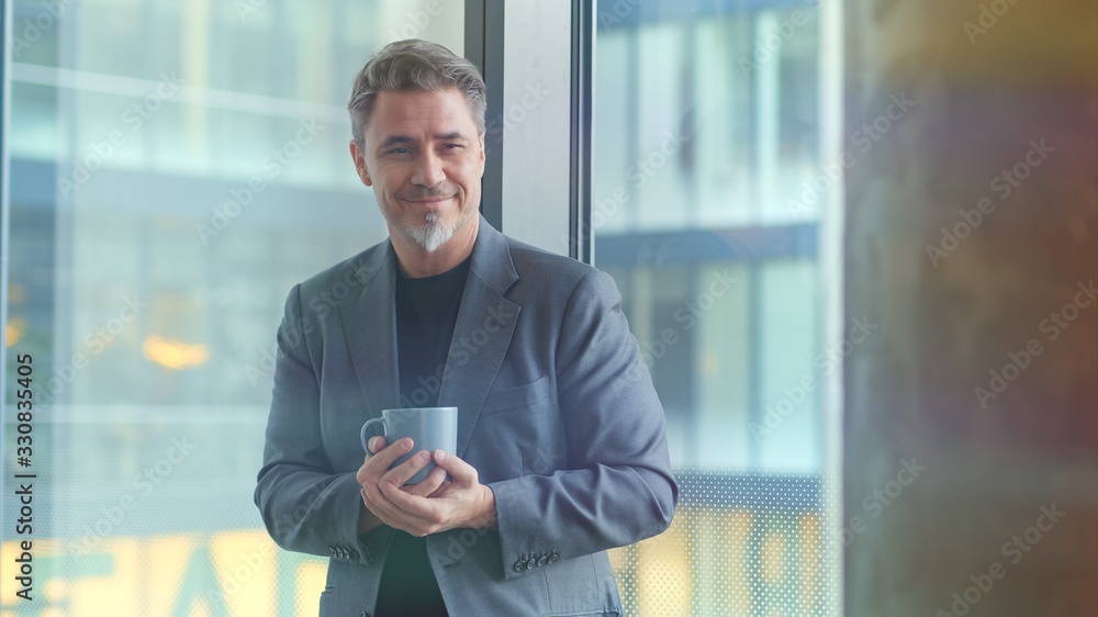 Mature businessman in office drinking coffee Mature businessman in office drinking coffee