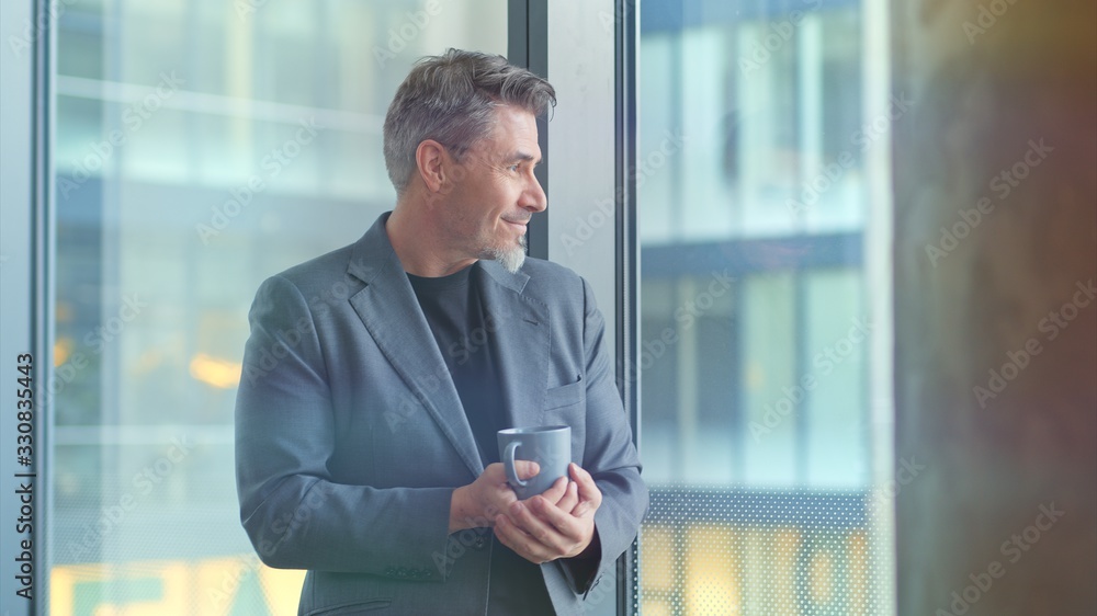 Mature businessman in office drinking coffee Mature businessman in office drinking coffee