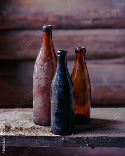 3 dusty old empty bottles in the barn