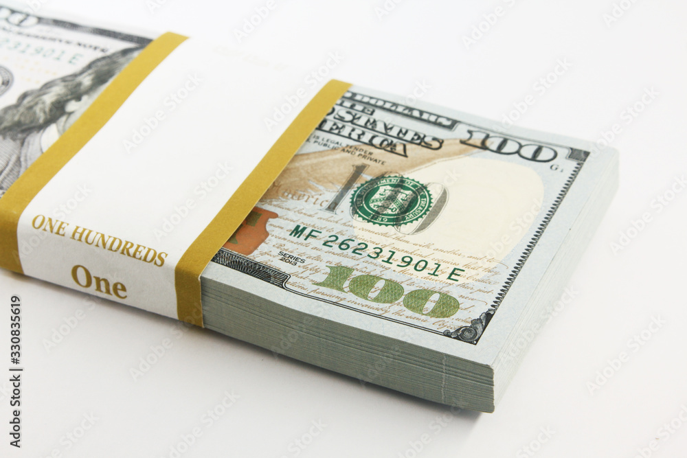 Stack of american money, one hundred dollar cash banknotes on white background, lot of one hundred dollar bills Stack of american money, one hundred dollar cash banknotes on white background, lot of one hundred dollar bills