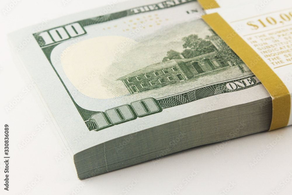Stack of american money, one hundred dollar cash banknotes on white background, lot of one hundred dollar bills Stack of american money, one hundred dollar cash banknotes on white background, lot of one hundred dollar bills