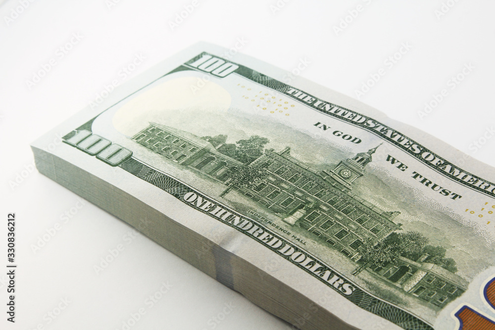 Stack of american money, one hundred dollar cash banknotes on white background, lot of one hundred dollar bills Stack of american money, one hundred dollar cash banknotes on white background, lot of one hundred dollar bills