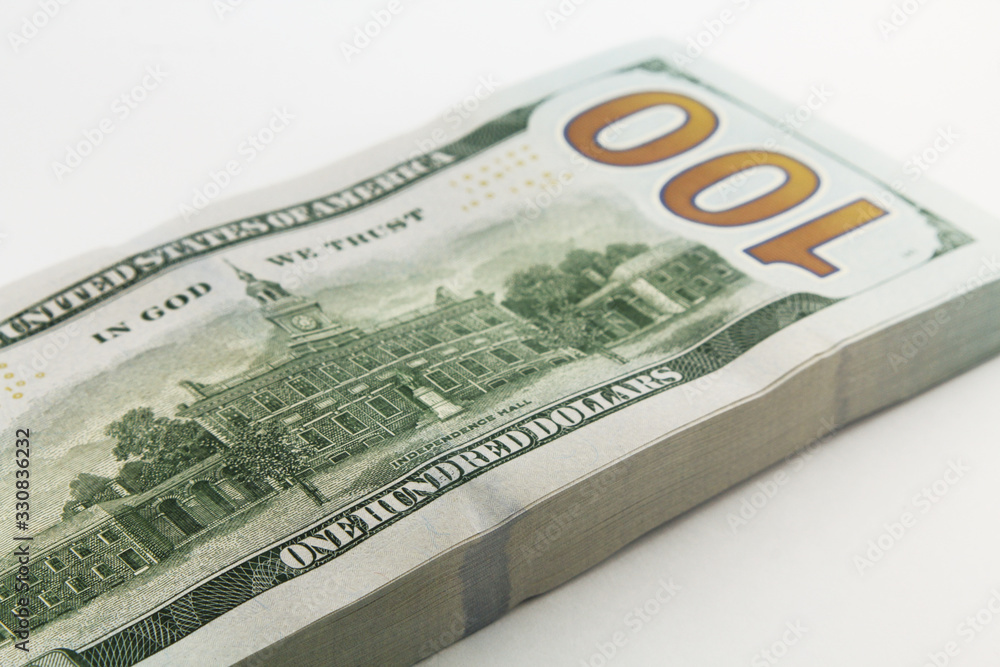Stack of american money, one hundred dollar cash banknotes on white background, lot of one hundred dollar bills Stack of american money, one hundred dollar cash banknotes on white background, lot of one hundred dollar bills