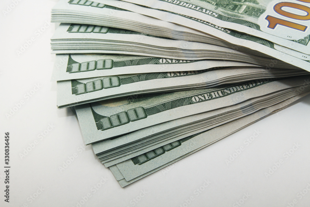 Stack of american money, one hundred dollar cash banknotes on white background, lot of one hundred dollar bills Stack of american money, one hundred dollar cash banknotes on white background, lot of one hundred dollar bills