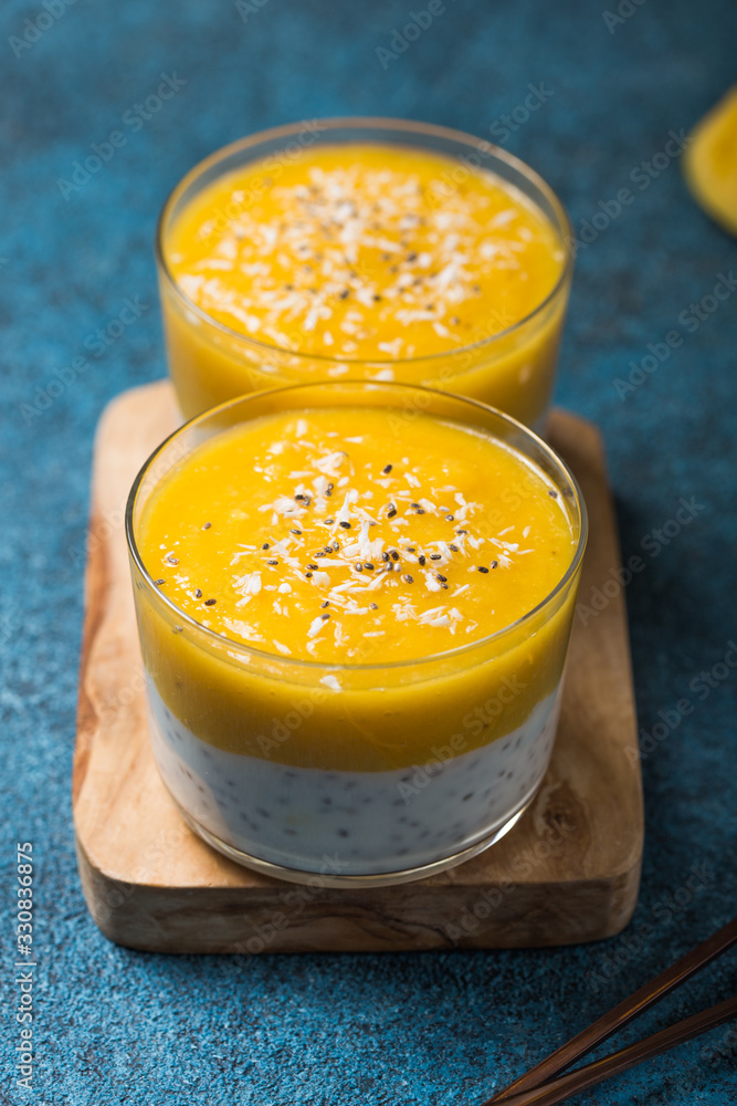 Chia seed pudding with mango in glass jars. Clean eating, healthy vegan vegetarian food concept Chia seed pudding with mango in glass jars. Clean eating, healthy vegan vegetarian food concept