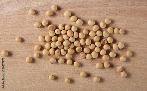 Organic raw soybeans on wooden chopping board background and texture