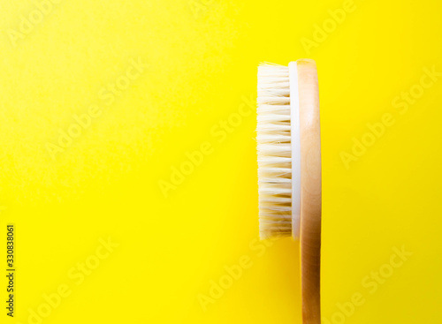 Dry massage. Brush made of natural cactus bristles  animals. Massage brush on a yellow background from different angles. Place for text. Macro brush.  Copy Space Handle anti-cellulite brush.