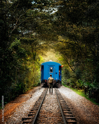  Young man with backpack misses train in the middle of nature photo