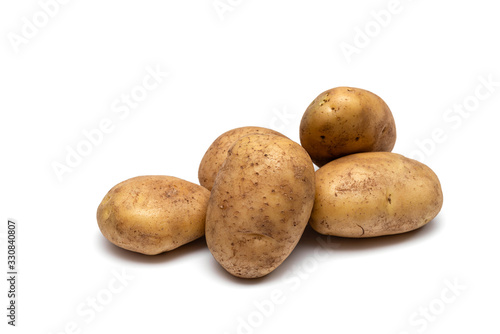 raw dirty potatoes on a white background