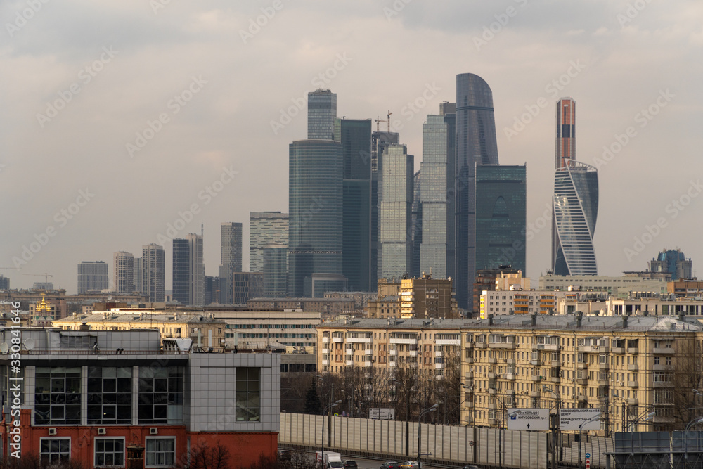 Skyscrapers in Moscow among low-rise buildings, spring afternoon Skyscrapers in Moscow among low-rise buildings, spring afternoon